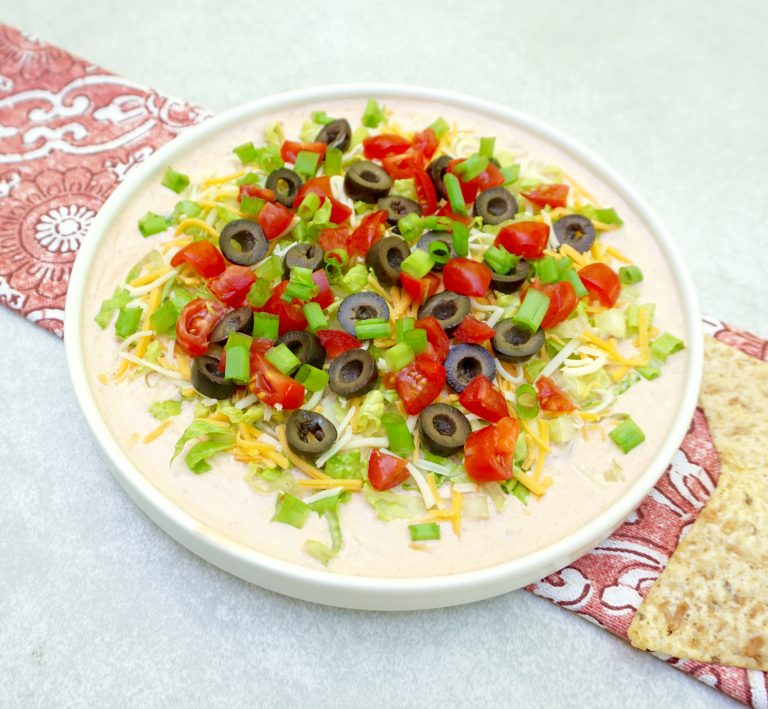 Taco Dip Combines Salsa And Sour Cream And Is Topped With Fresh Veggies.