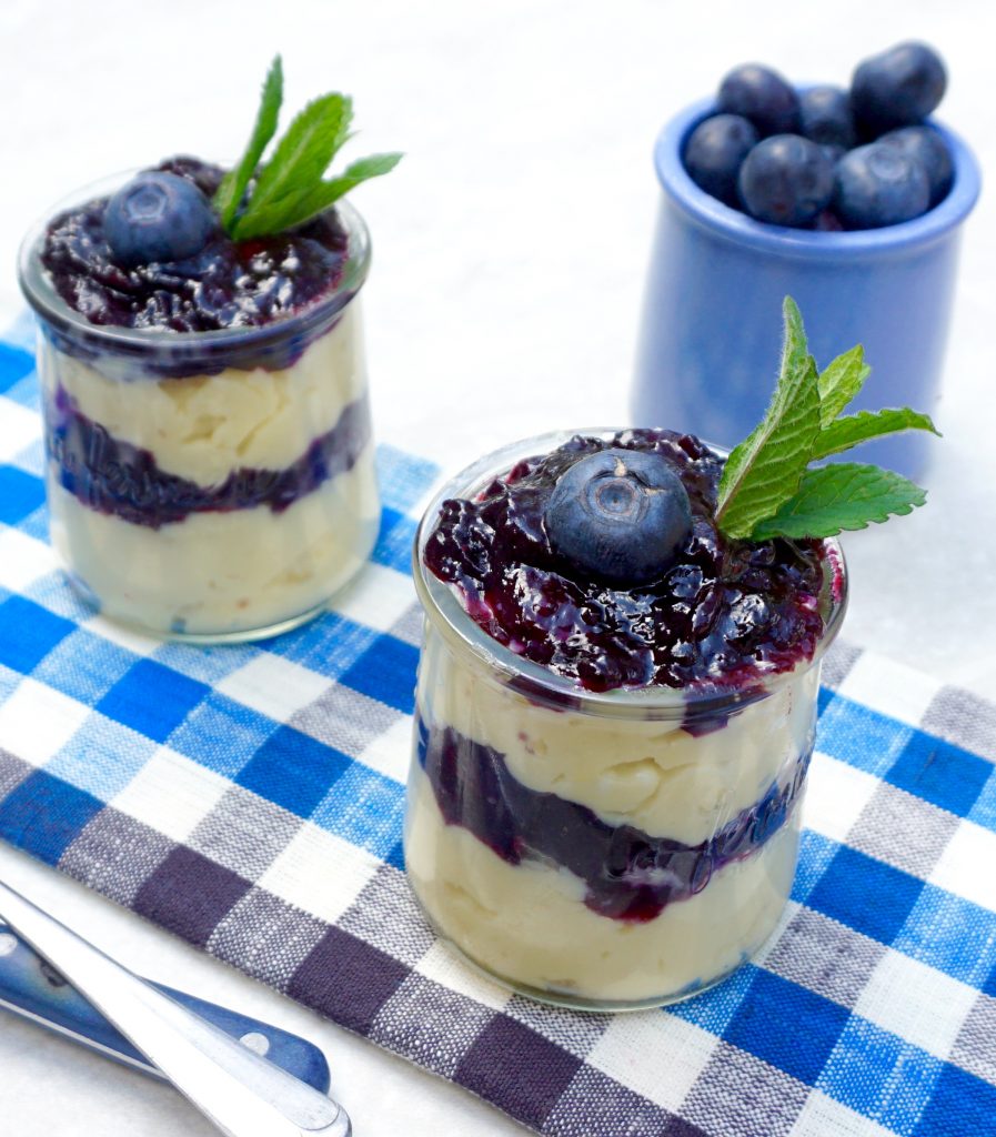 Delicious Blueberry tartlets with vanilla custard cream on grey rustic  wooden background Stock Photo - Alamy