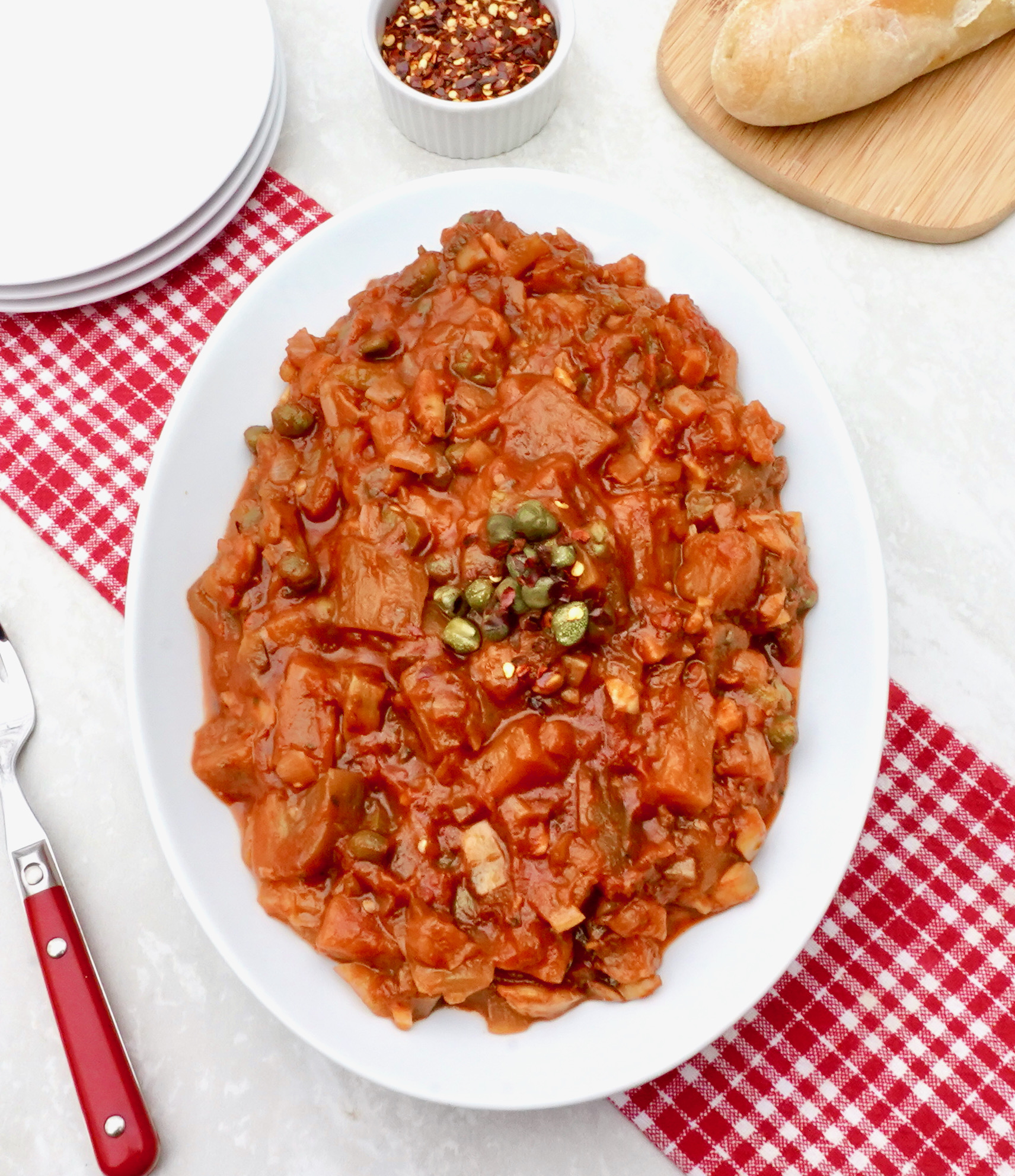 Caponata is a tomato based eggplant side dish can be served hot or cold.