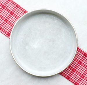 Greased and floured 10" round cake pan